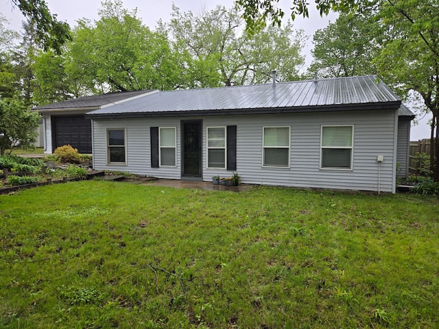 337 Lake Ave N, Spicer, MN 56288 - back of property featuring metal roof, a yard, and a garage