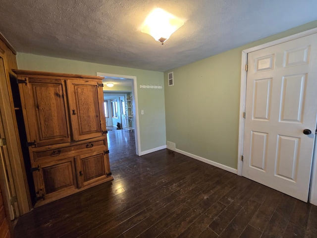 337 Lake Ave N, Spicer, MN 56288 - spare room featuring baseboards, dark wood-style floors, and a textured ceiling
