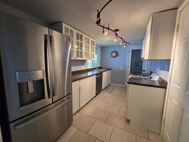 337 Lake Ave N, Spicer, MN 56288 - kitchen with stainless steel fridge, dishwasher, dark countertops, and white cabinets