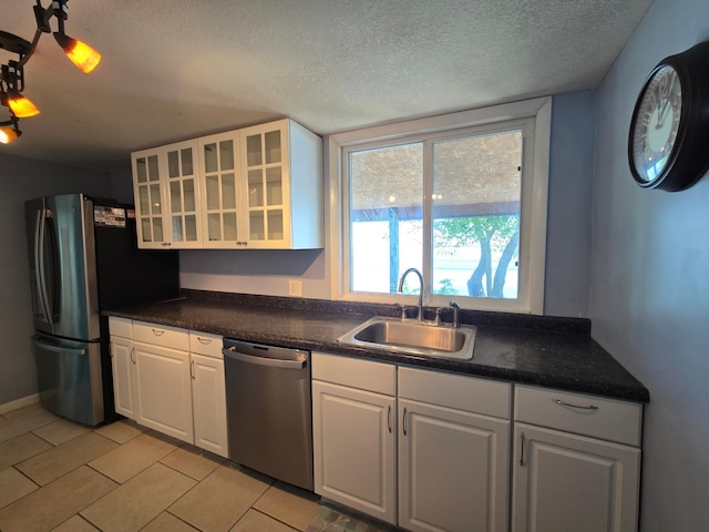 337 Lake Ave N, Spicer, MN 56288 - kitchen with appliances with stainless steel finishes, a sink, white cabinetry, a textured ceiling, and glass insert cabinets