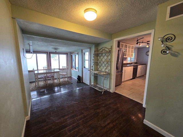 337 Lake Ave N, Spicer, MN 56288 - hallway with a textured ceiling, baseboards, and wood finished floors