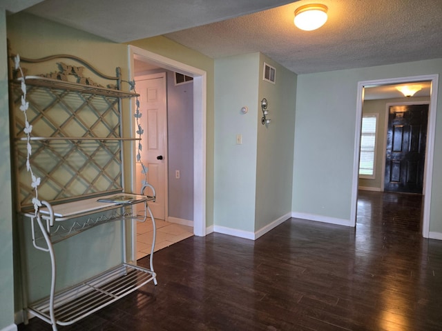 337 Lake Ave N, Spicer, MN 56288 - corridor with wood finished floors, a textured ceiling, and baseboards