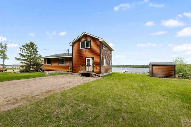 2648 Lake Shore Dr, Scandia Valley Twp, MN 56466 - rear view of property with a water view, a yard, and dirt driveway