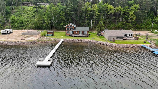 2648 Lake Shore Dr, Scandia Valley Twp, MN 56466 - dock area with a forest view, a deck with water view, and a yard