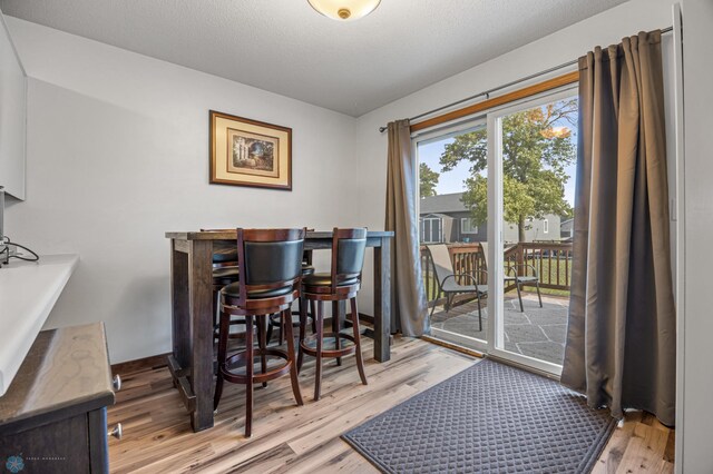805 7th St NE, Dilworth, MN 56529 - dining room featuring light wood-style floors and a bar