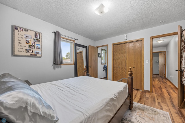 805 7th St NE, Dilworth, MN 56529 - bedroom with a textured ceiling, wood finished floors, and a closet