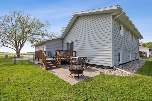 805 7th St NE, Dilworth, MN 56529 - back of property with an outdoor fire pit, a wooden deck, and a patio