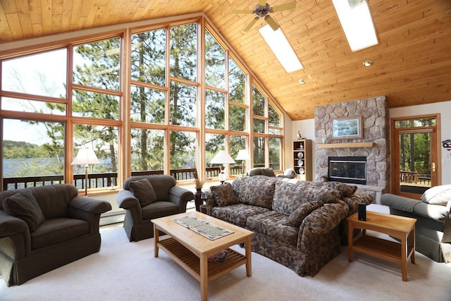 1880 Everett Rd S, Greenwood Twp, MN 55790 - carpeted living room featuring a baseboard heating unit, high vaulted ceiling, plenty of natural light, a fireplace, and a skylight