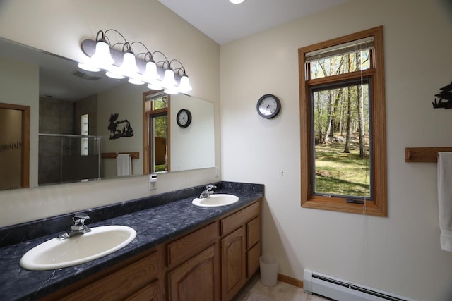 1880 Everett Rd S, Greenwood Twp, MN 55790 - full bath featuring a baseboard heating unit, a stall shower, plenty of natural light, and double vanity