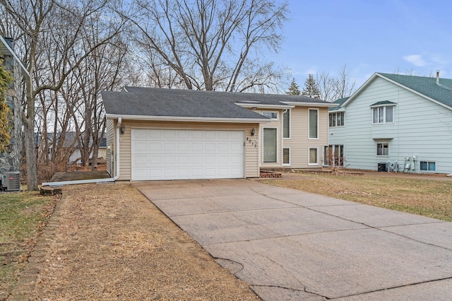 4017 Fordham Dr NE, Saint Anthony, MN 55421 - view of front facade featuring driveway, a garage, central AC, and roof with shingles