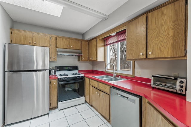 4017 Fordham Dr NE, Saint Anthony, MN 55421 - kitchen featuring stainless steel appliances, under cabinet range hood, a sink, brown cabinetry, and a skylight