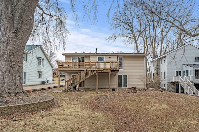 4017 Fordham Dr NE, Saint Anthony, MN 55421 - back of property with stairs, a wooden deck, and cooling unit