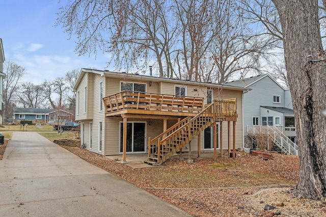 4017 Fordham Dr NE, Saint Anthony, MN 55421 - back of property featuring stairs, a deck, and concrete driveway