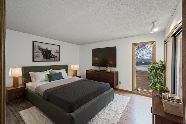 4017 Fordham Dr NE, Saint Anthony, MN 55421 - bedroom featuring wood finished floors and a textured ceiling