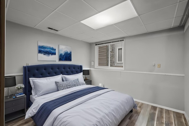 4017 Fordham Dr NE, Saint Anthony, MN 55421 - bedroom featuring wood finished floors, a drop ceiling, and baseboards