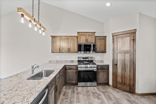 872 Watertown Ave, Delano, MN 55328 - kitchen with stainless steel appliances, vaulted ceiling, a sink, light wood-style flooring, and light stone countertops