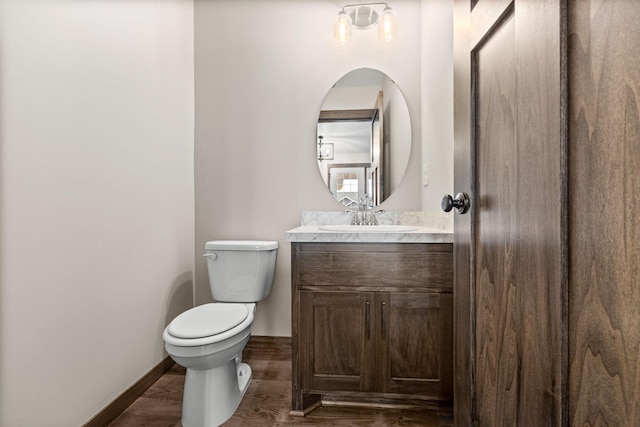 872 Watertown Ave, Delano, MN 55328 - half bath featuring vanity, toilet, wood finished floors, and baseboards