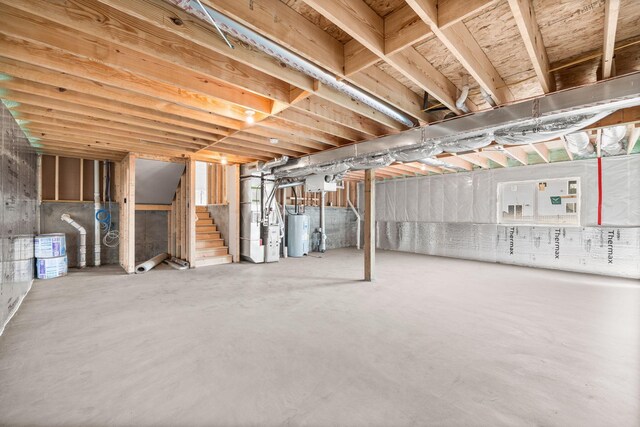 872 Watertown Ave, Delano, MN 55328 - unfinished below grade area with water heater, heating unit, and stairs