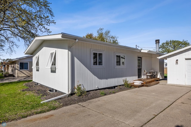 3017 8th St N, Fargo, ND 58102 - view of home's exterior with a patio area and concrete driveway