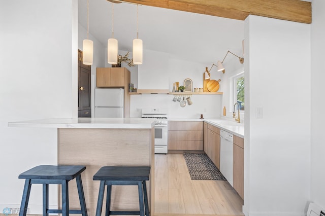 3017 8th St N, Fargo, ND 58102 - kitchen featuring white appliances, a sink, open shelves, a breakfast bar area, and a baseboard heating unit