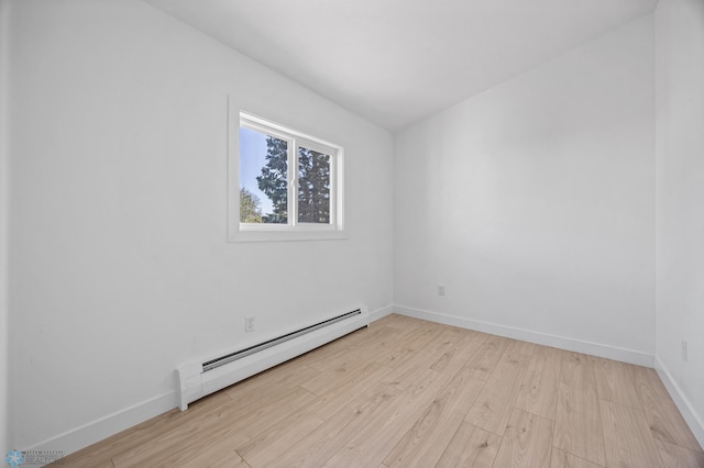 3017 8th St N, Fargo, ND 58102 - unfurnished room featuring a baseboard radiator, light wood-type flooring, and baseboards