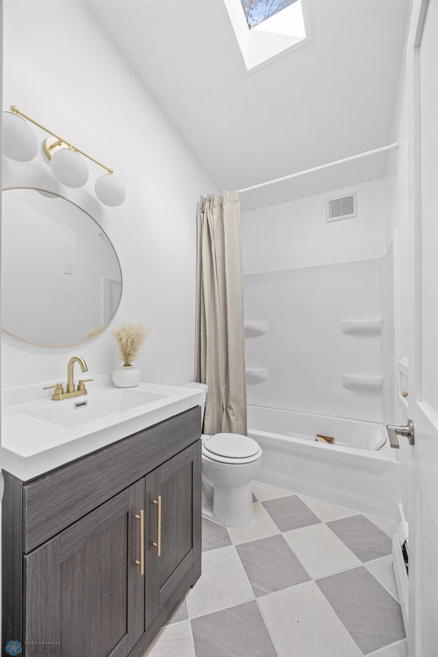 3017 8th St N, Fargo, ND 58102 - bathroom featuring vanity, shower / bath combo, a skylight, toilet, and lofted ceiling