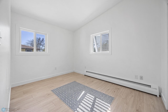 3017 8th St N, Fargo, ND 58102 - unfurnished room with baseboard heating, plenty of natural light, wood finished floors, and lofted ceiling