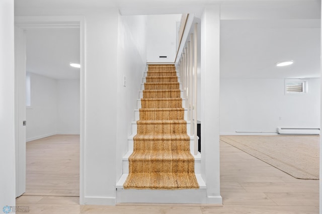 3017 8th St N, Fargo, ND 58102 - staircase with baseboard heating, wood finished floors, and baseboards