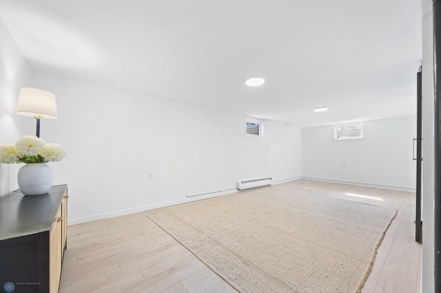 3017 8th St N, Fargo, ND 58102 - unfurnished room with a baseboard radiator, light wood-style flooring, and baseboards