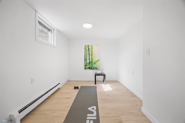 3017 8th St N, Fargo, ND 58102 - exercise room with a baseboard heating unit, light wood-style flooring, and baseboards