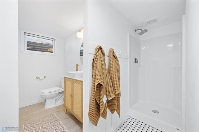 3017 8th St N, Fargo, ND 58102 - bathroom with vanity, toilet, a shower, wood finished floors, and baseboards