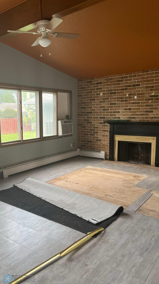 3017 8th St N, Fargo, ND 58102 - unfurnished living room with a fireplace, vaulted ceiling, cooling unit, wood finished floors, and a ceiling fan