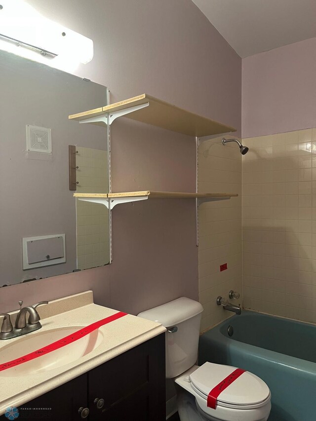 3017 8th St N, Fargo, ND 58102 - bathroom with toilet, vanity, and washtub / shower combination