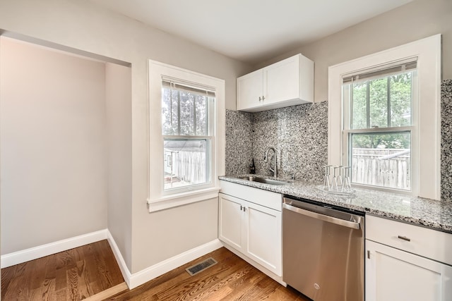 4245 11th Ave S, Minneapolis, MN 55407 - kitchen featuring stainless steel dishwasher, a sink, healthy amount of natural light, and wood finished floors