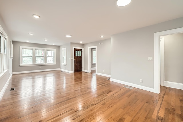 4245 11th Ave S, Minneapolis, MN 55407 - unfurnished living room featuring baseboards, light wood-style flooring, and recessed lighting