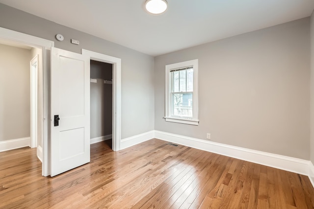 4245 11th Ave S, Minneapolis, MN 55407 - unfurnished bedroom with light wood-style flooring, baseboards, and a closet