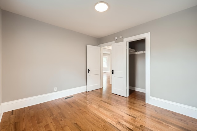 4245 11th Ave S, Minneapolis, MN 55407 - unfurnished bedroom with light wood-type flooring, baseboards, and a closet