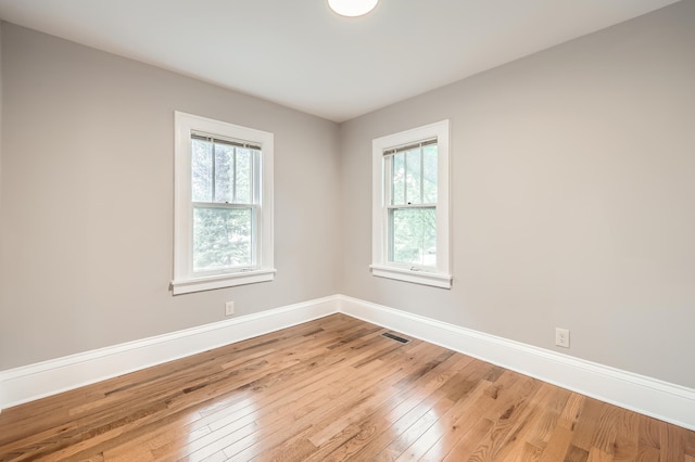 4245 11th Ave S, Minneapolis, MN 55407 - spare room featuring wood-type flooring, healthy amount of natural light, and baseboards