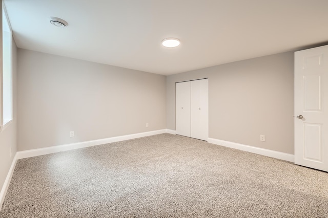4245 11th Ave S, Minneapolis, MN 55407 - unfurnished bedroom featuring baseboards, a closet, and light colored carpet