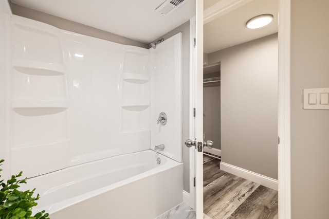 4245 11th Ave S, Minneapolis, MN 55407 - full bathroom featuring baseboards, shower / tub combination, and wood finished floors