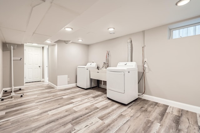 4245 11th Ave S, Minneapolis, MN 55407 - washroom with washer and dryer, light wood-style floors, baseboards, and recessed lighting