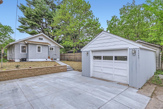 4245 11th Ave S, Minneapolis, MN 55407 - detached garage featuring cooling unit and concrete driveway