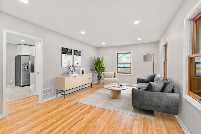 719 9th St E, Glencoe, MN 55336 - living room featuring light wood-type flooring, recessed lighting, and baseboards