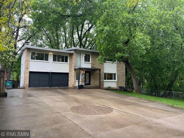 2844 Monterey Pkwy, Saint Louis Park, MN 55416 - view of front of home featuring concrete driveway, a garage, and brick siding