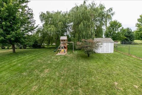 218 10th Ave NW, Byron, MN 55920 - view of yard featuring a playground and view of scattered trees