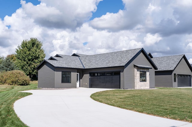724 Westland Ln, New London, MN 56273 - view of front of home featuring an attached garage, a shingled roof, a front yard, and driveway