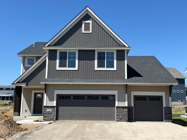 17967 Hawksbill Dr, Lakeville, MN 55044 - craftsman inspired home featuring stone siding, concrete driveway, roof with shingles, and a garage