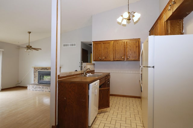 16477 Five Hawks Ave SE, Prior Lake, MN 55372 - kitchen with white appliances, a sink, ceiling fan, brown cabinets, and a brick fireplace