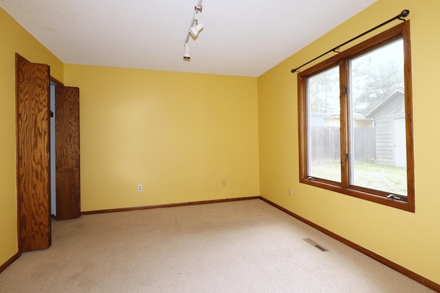 16477 Five Hawks Ave SE, Prior Lake, MN 55372 - unfurnished room featuring light carpet, healthy amount of natural light, and baseboards