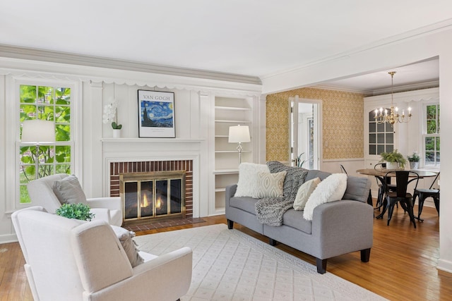 4378 Browndale Ave, Edina, MN 55424 - living room with ornamental molding, wallpapered walls, wood finished floors, a chandelier, and healthy amount of natural light